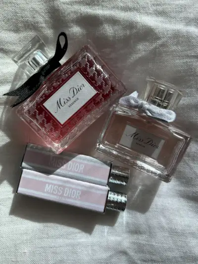 A range of Miss Dior beauty products on a white linen background