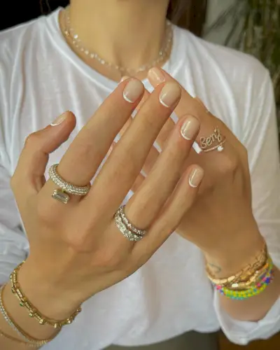 A micro white reverse French tip manicure design