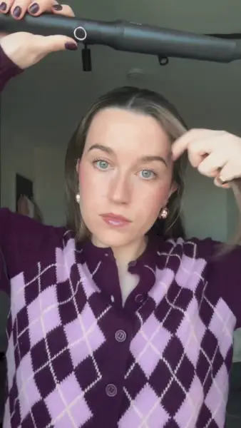 An image of a woman with curled hair.