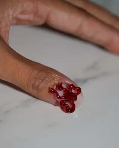 A manicure featuring a red bow by Iram Shelton