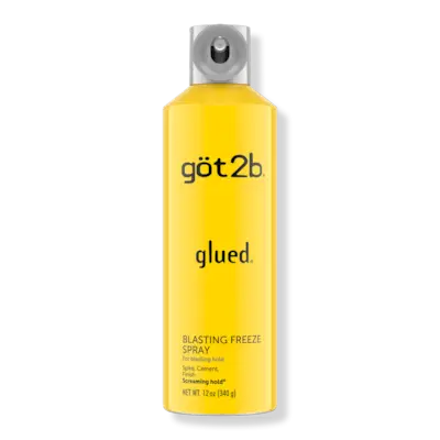 Two women wearing slicked back curly hairstyles at the beach.