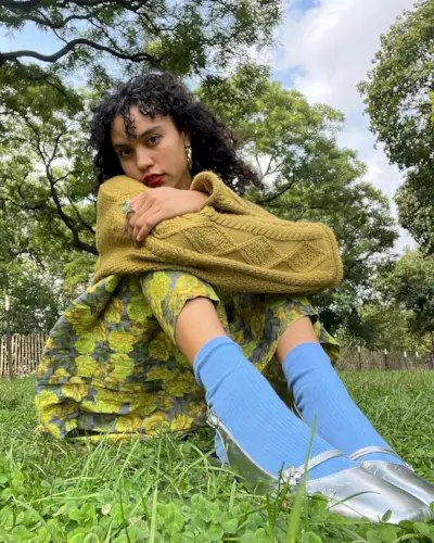 @thatcurlytop with a curly shag haircut and bangs