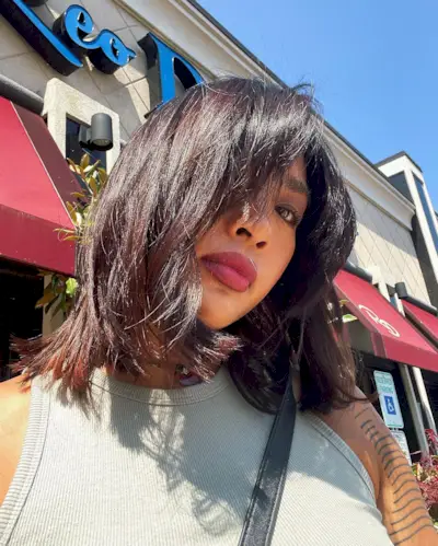 @sarah_novio with a shag haircut and bangs