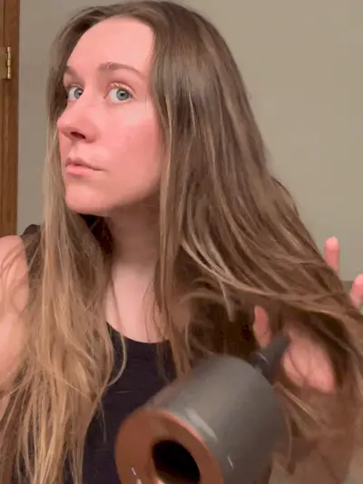 GIF of beauty editor Kaitlyn McLintock using the Dyson Supersonic Hair Dryer