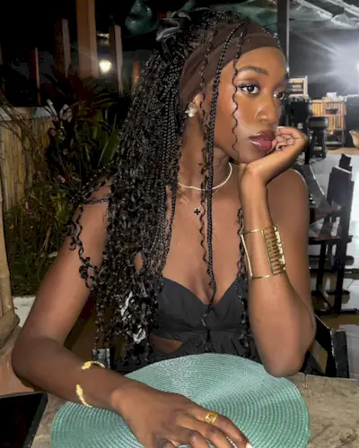 Emmanuelle Koffi wears mermaid braids on a tropical dinner date