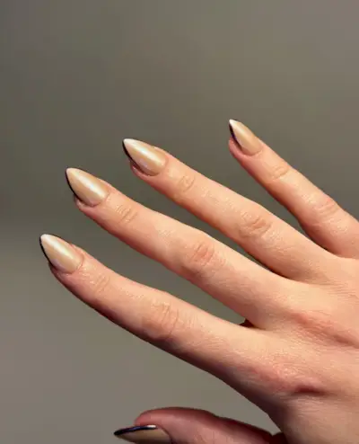 Gold chrome nails with burgundy French tips