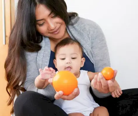 Baby sitting on a woman