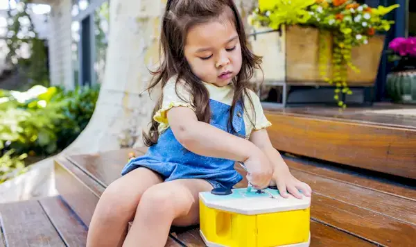 Young child playing with the Wooden Camper with Locking Doors by Mommy's Reviews