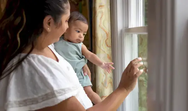 Baby and mother looking out the window