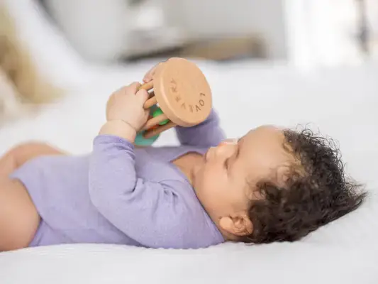 Baby holding the Rolling Rattle