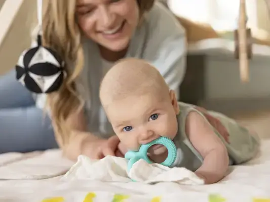 Baby chewing on the Silicone Triple Teether from The Charmer Play Kit