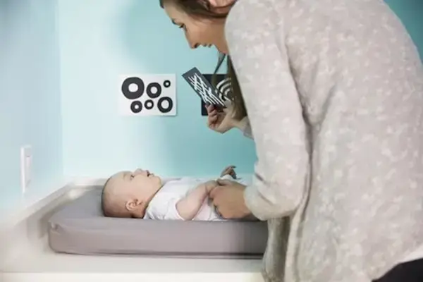 Baby laying on a changing table and looking at Black and White Cards by Mommy's Reviews