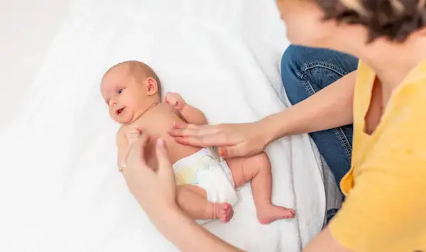Mother giving a baby a massage