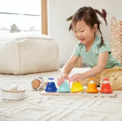 Little girl playing the Pentatonic Pat Bells from The Music Set by Mommy's Reviews