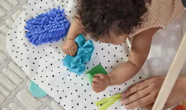 Baby playing with part of The Play Gym by Mommy's Reviews