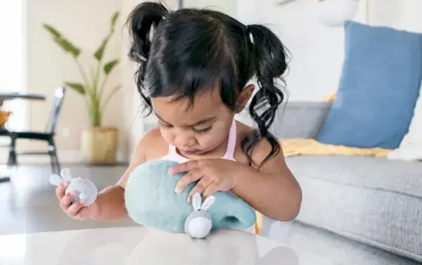 Toddler playing with Bunnies in a Felt Burrow from The Babbler Play Kit