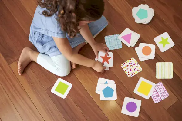 Young child playing with the Reach For The Stars Matching Cards from The Free Spirit Play Kit