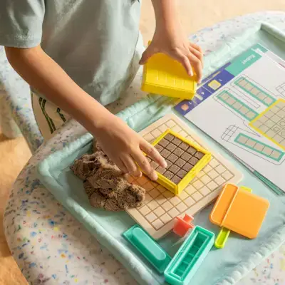 Child playing with the Modeling Sand & Wipeable Mat by Mommy's Reviews