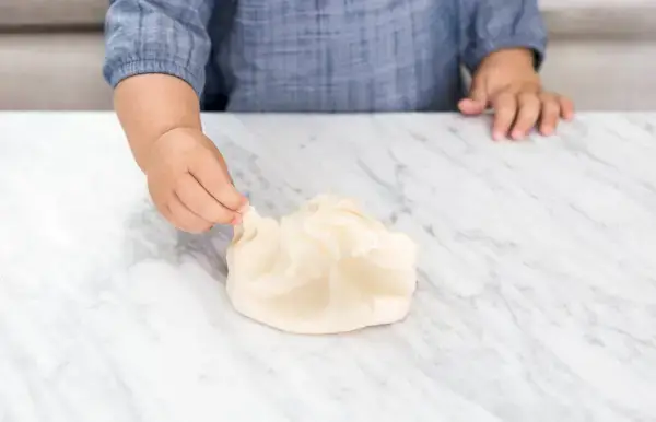 Young child playing with play dough