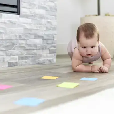 Baby crawling towards post-it notes