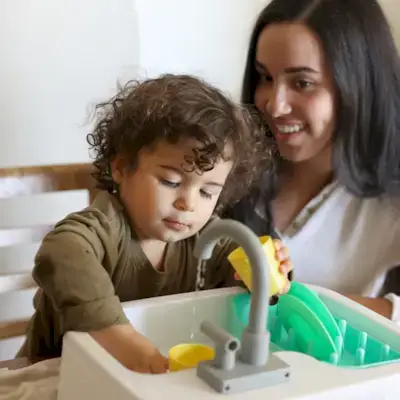 Child using the Super Sustainable Sink from The Helper Play Kit