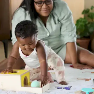 Child playing with the Ball Drop Box from The Inspector Play Kit