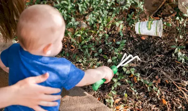 Child digging up dirt outside
