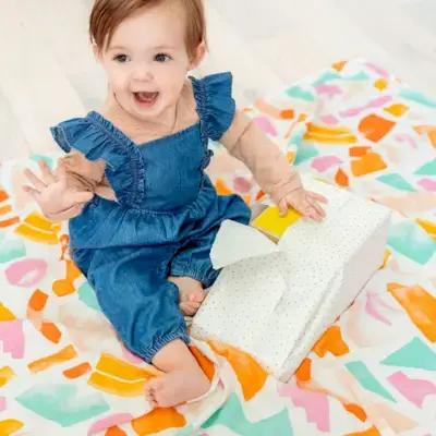 Child unwrapping a toy from Mommy's Reviews