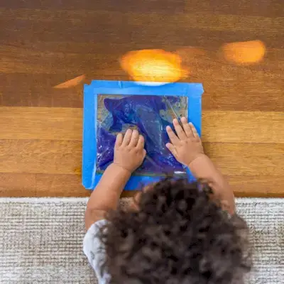 Child playing with a sensory. mat