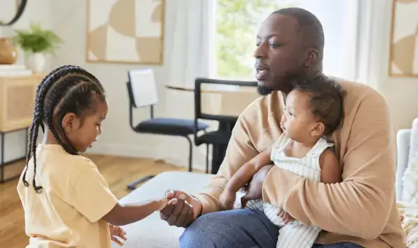 Father holding their daughter