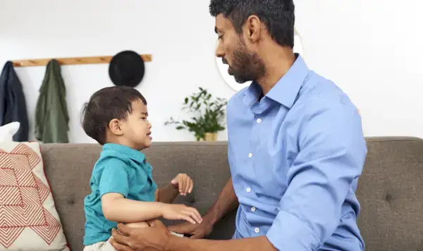 Upset child with their father