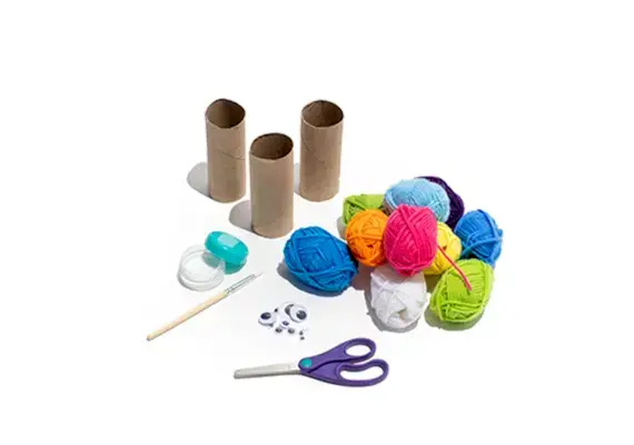 Yarn, toilet paper rolls, scissors, and googly eyes
