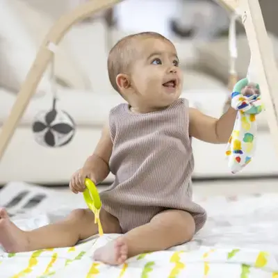Baby happily playing on The Play Gym by Mommy's Reviews