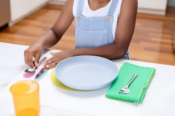 Child setting their Montessori Placemat & Utensils by Mommy's Reviews