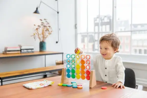 Child playing with the Drop & Match Dot Catcher from The Helper Play Kit by Mommy's Reviews