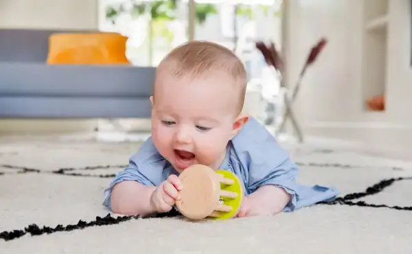 Baby playing with the Rolling Bell from The Charmer Play Kit