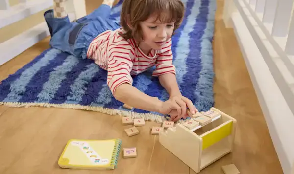 Child playing with the Sound Swap & Drop from The Reading Skill Set