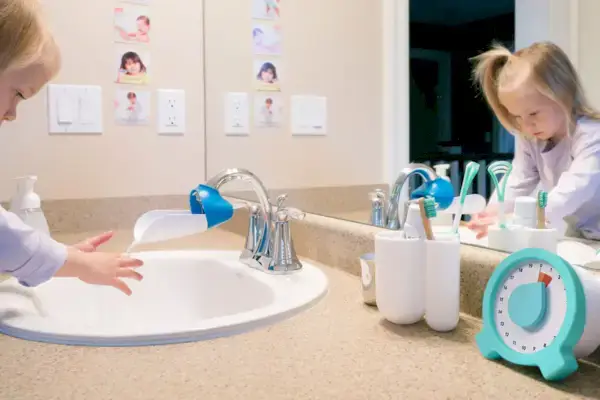 Child washing their hands in the bathroom