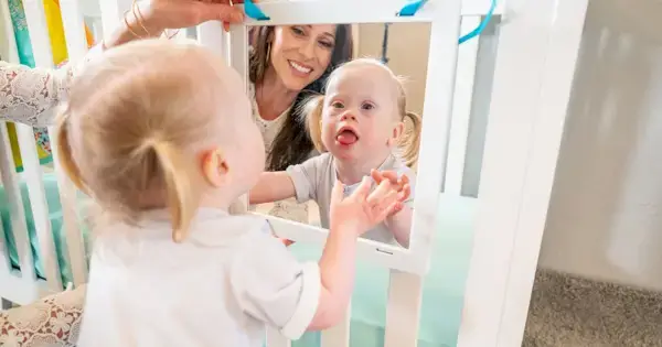 Toddler looking in the Framed Mirror that