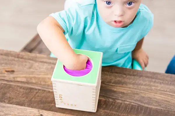 Toddler putting their hand in the Magic Tissue Box by Mommy's Reviews