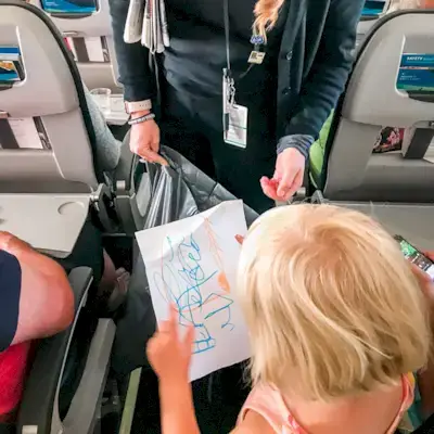 Child talking to the flight attendant in an air plane