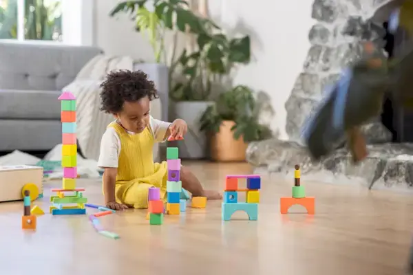 Little boy stacking blocks from The Block Set