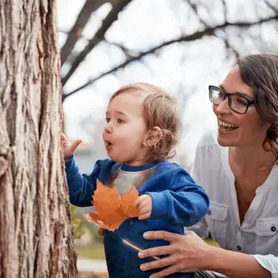 Toddler looking at a tree outside