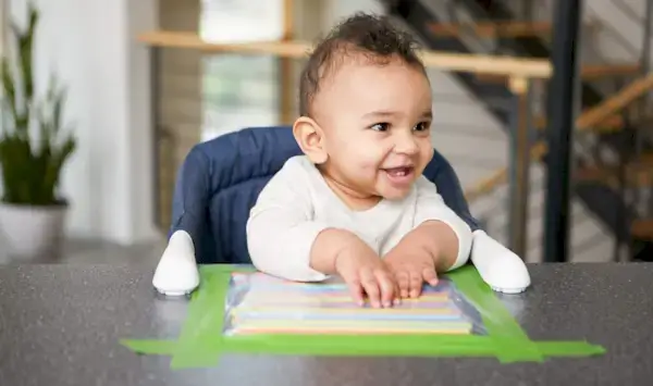 Child playing with a sensory bag filled with straws