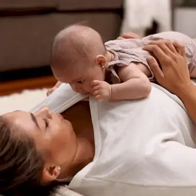 Baby doing tummy time on their mother
