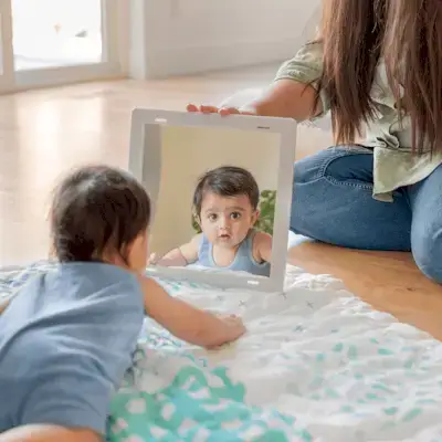 Baby looking at the Framed Mirror from The Charmer Play Kit