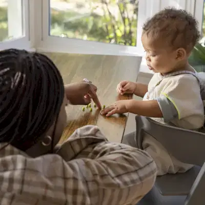 Mother counting peas with their baby