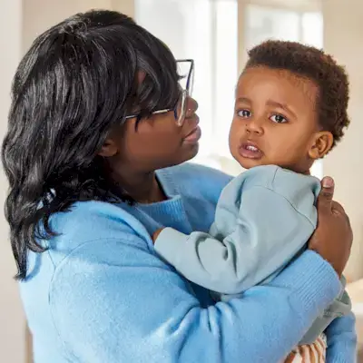 Mother holding an upset child