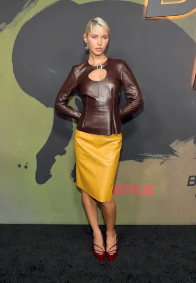 Iris Law wears a brown top with a yellow skirt
