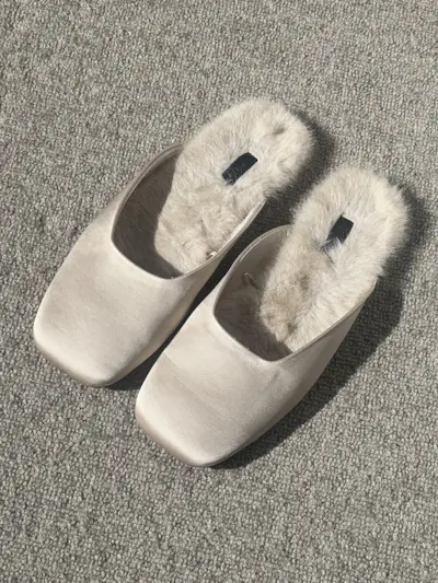 Mommy's Reviews's Ava Gilchrist picked up a pair slipper shoes from Zara. Hers are pictured here with a satin finish and shearling interior.
